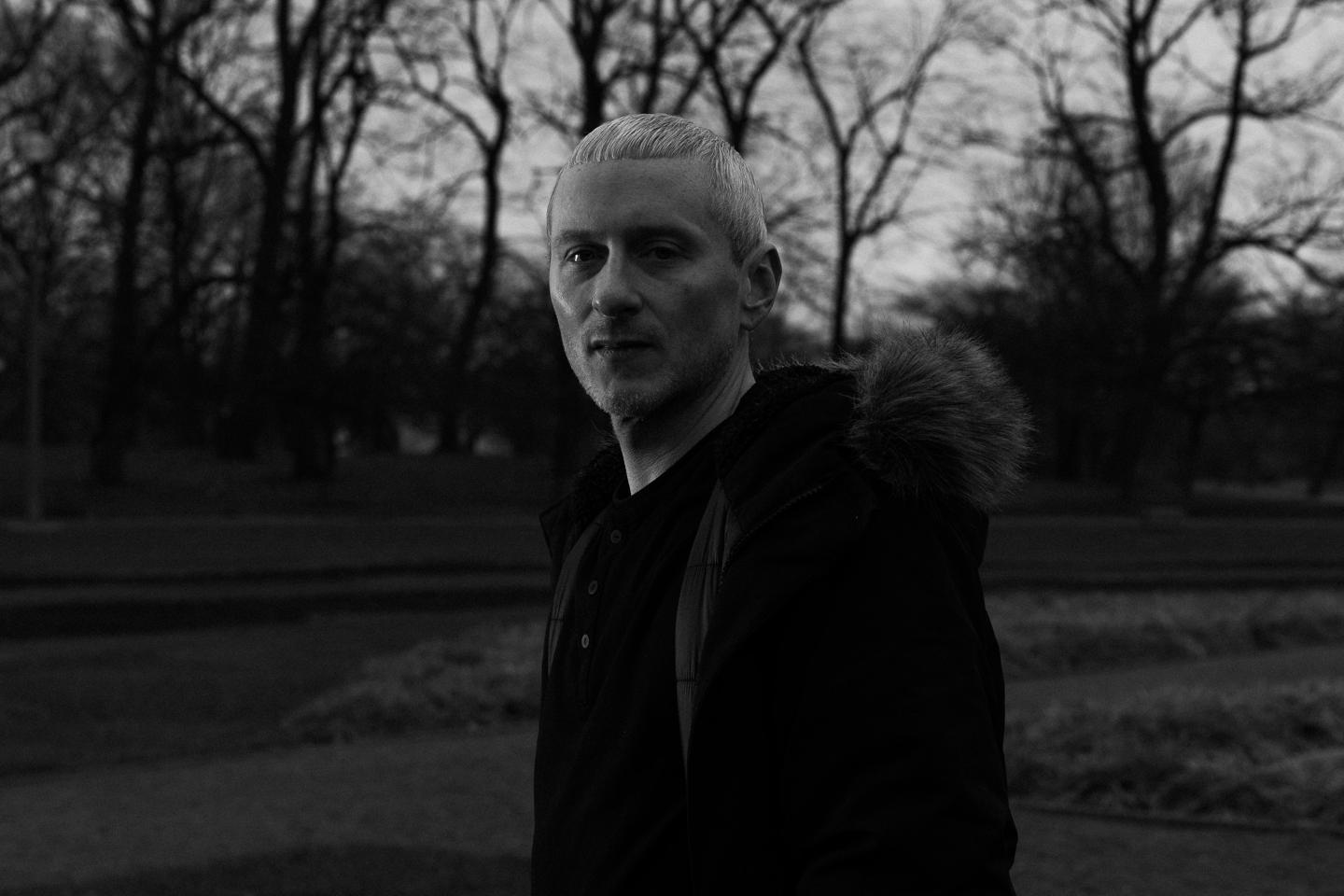 Black-and-white portrait of Jason Patrick outdoors